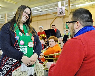 Jeff Lange | The Vindicator Elizabeth John, art and music teacher at St. Joseph the Provider in Youngstown, smiles as her boyfriend Stephen Orlando, assistant band director at Girard High School, proposes after a performance by a tuba quartet, Saturday afternoon at the Eastwood Expo Center. Elizabeth and Stephen first met four years ago at the Tubachristmas concert.
