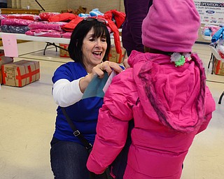 Celeste Lisko of the Boardman Rotary Club helps Nykiya Wright, 4, pick out a coat from the Salvation Army in Youngstown on Dec. 6. "It's great watching the little kids getting their new coats," Lisko said.