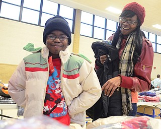 Montell Cohill, 10, of Youngstown tries on coats with his mom Sonia at the Salvation Army in Youngstown on Dec. 6. "It was much needed," Sonia Cohill said. "I appreciate the help."