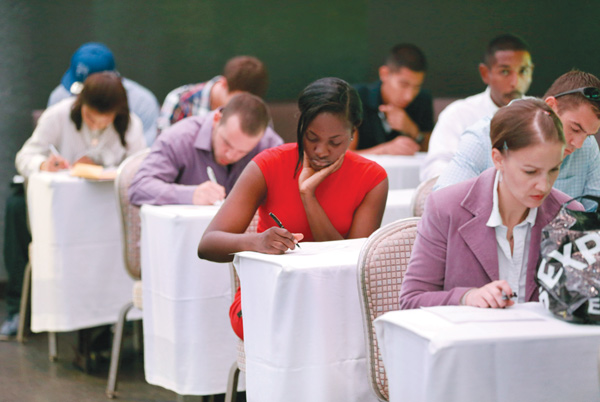 Job seekers fill out forms before being interviewed during a job fair at Fontainebleau Miami Beach in Miami Beach, Fla. For the first time since the Great Recession ended 5 1⁄2 years ago, America’s unemployed are now as likely to be hired as to stop looking for a job.
