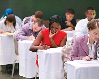 Job seekers fill out forms before being interviewed during a job fair at Fontainebleau Miami Beach in Miami Beach, Fla. For the first time since the Great Recession ended 5 1⁄2 years ago, America’s unemployed are now as likely to be hired as to stop looking for a job.