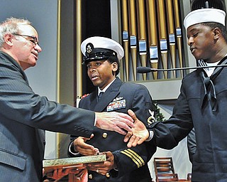 Adrian Biviano, left, shakes the hand of Navy Personnel Specialist 3 Craig Wingate after Wingate and Navy Chief
Jason Hatton had presented medals that Biviano’s father, Lucian “Sam” Biviano, a Pearl Harbor survivor,
earned in World War II but had never received. The ceremony was Monday, the day after the 73rd anniversary
of the Japanese attack on Pearl Harbor on Dec. 7, 1941.