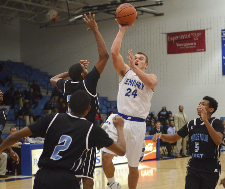 Katie Rickman | The Vindicator.Poland's Austin Wilson (24) goes up for a basket but is blocked by East's Daylen Daniels (24) during the third period of the game at Poland High School on Tuesday, Dec. 9, 2014.