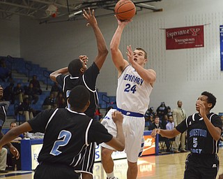 Katie Rickman | The Vindicator.Poland's Austin Wilson (24) goes up for a basket but is blocked by East's Daylen Daniels (24) during the third period of the game at Poland High School on Tuesday, Dec. 9, 2014.
