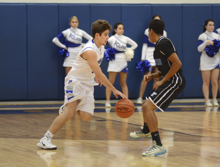 Katie Rickman | The Vindicator.Poland's Nick Gajdos (3) moves up court and pushes past  East's Ce'andre Backus (5) during the first period of the game at Poland High School on Tuesday, Dec. 9, 2014.