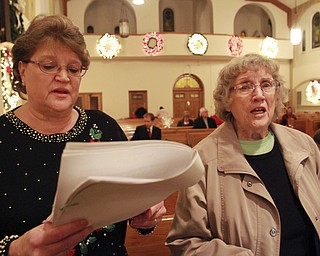 William d Lewis The vindicator  Sue Petiya, left, and Mary Ann Poczatek both members of St casimir Choir, sing traditional Polish vigil dinner and singing Sunday 12-7-14.