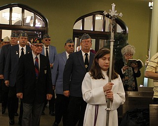 Alter server, Alyssa Ritter (12) of Boardman , carries a crucifix while leading members of the VFW into servers at St. Stanislaus Church in Youngstowns during the 73rd annual Pearl Harbor Mass on Sunday morning.  Dustin Livesay  |  The Vindicator  12/7/14  Youngstown.