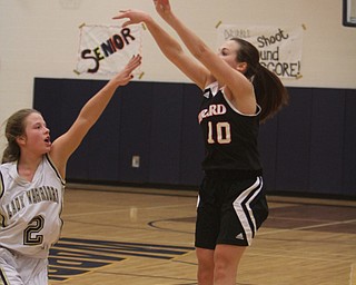 Girard's Ali Ciminero (10) puts up a 3-pointer while being defended by Brookfield's McKenzie Drapola (2) during the first half of Wednesday nights matchup at Bookfield High School. Dustin Livesay  |  The Vindicator  12/10/14  Brookfield, Ohio.