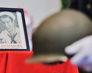 Jeff Lange | The Vindicator  Seen above is a photo of Lucian Sam Biviano SM 1c, as a member of the honor guard walks by with a helmet to honor those who have fallen, Monday morning at the First Presbyterian Church in Warren. Biviano served in the Navy from 1941 to 1945.