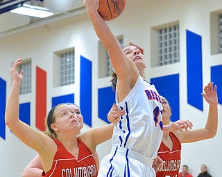 Jeff Lange | The Vindicator  Heather Lude of Reserve (center) looks to the basket as she goes for a layup between Clippers' Lauren Schlueter (21) and Emily Witmer (24) in the first period of Thursday night's action at Western Reserve High School.