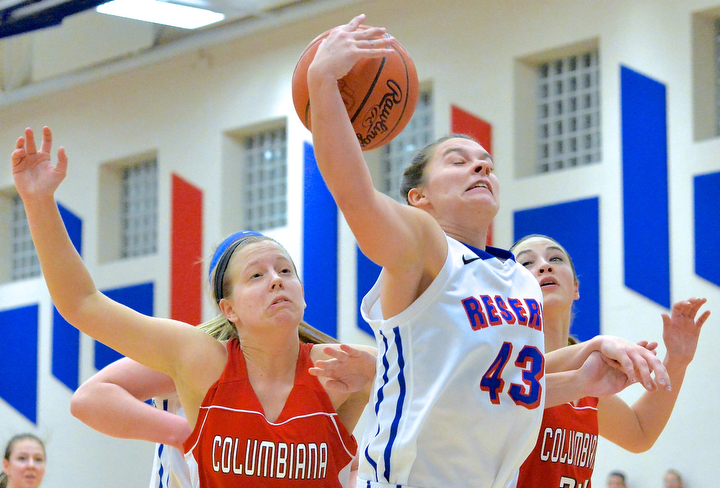 Jeff Lange | The Vindicator  Reserve's Heather Lude (43) brings down a rebound under the basket between Columbiana's Lauren Schlueter (left) and Emily Witmer  (right) in the first period of Thursday night's matchup at Western Reserve.