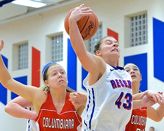 Jeff Lange | The Vindicator  Reserve's Heather Lude (43) brings down a rebound under the basket between Columbiana's Lauren Schlueter (left) and Emily Witmer  (right) in the first period of Thursday night's matchup at Western Reserve.