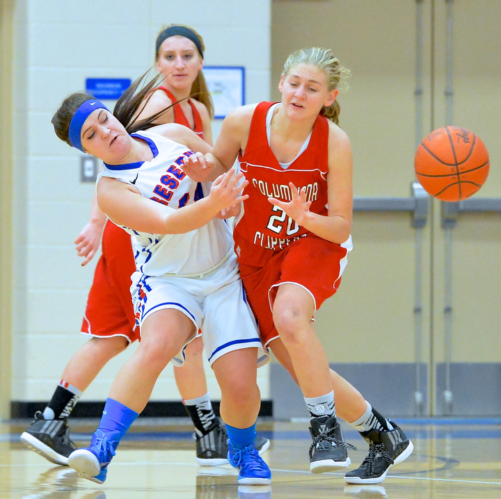 Jeff Lange | The Vindicator  Columbiana's Alexis Cross (20) drops the ball as she collides with Reserve's Tory White in the first half of Thursday night's game at Western Reserve High School.