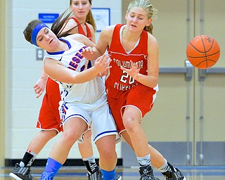 Jeff Lange | The Vindicator  Columbiana's Alexis Cross (20) drops the ball as she collides with Reserve's Tory White in the first half of Thursday night's game at Western Reserve High School.