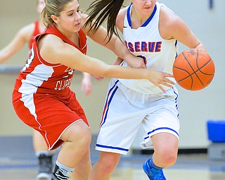 Jeff Lange | The Vindicator  Columbiana's Brynn Pennell (left) reaches for the ball as Reserve's Lauren Falasca takes it down the court during first half action at Western Reserve High School, Thursday night.
