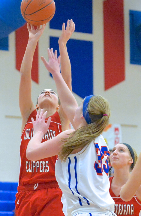Jeff Lange | The Vindicator  Columbiana's Emily Witmer (left) makes a 2 over the defense of Reserve's Aleah Hughes in the third period of Thursday night's matchup at Western Reserve High School.