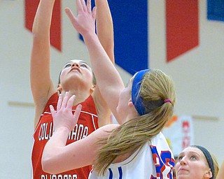 Jeff Lange | The Vindicator  Columbiana's Emily Witmer (left) makes a 2 over the defense of Reserve's Aleah Hughes in the third period of Thursday night's matchup at Western Reserve High School.