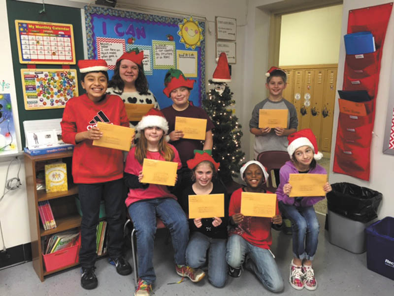 
Fifth- and sixth-grade students in Megan Key’s class at Boardman Center Middle School wrote Christmas letters
to their heroes — local veterans. From left to right in front are Julie Siembieda, Emma Pellin, Marcell Tomlin and 
Gabriella Ryan. Standing are Patsy Carlini-Pritt, Angela Bulone, Dillon Moore and Colin Thomas.  SPECIAL TO THE VINDICATOR