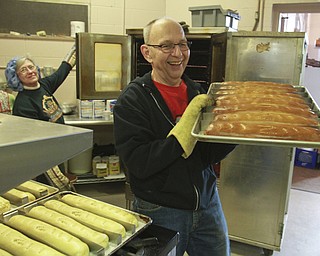 William D Lewis The Vindincator  Nick Vansuch carries a tray of kolachi from the oven at St John the Baptist Church in Campbell. Church members gatherd to make to popular holiday treats 12-9-14.