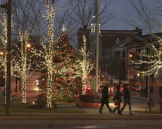 William D. Lewis The Vindicator Pedestrians walk as holiday lights adorn downtown Youngstown.