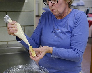 Katie Rickman | The Vindicator. Sandy Dorman fills a clothespin cookie at Bethel Lutheran Church in Boardman on Dec. 10, 2014.