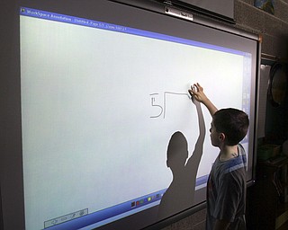William D. Lewis the Vindicator  CH Campbell School( canfield) 4th grade student Landon Palotsee at at work on new interactive board 12.12.14