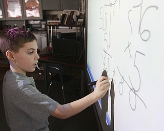 William D. Lewis the Vindicator  CH Campbell School( canfield) 4th grade student Landon Palotsee at at work on new interactive board 12.12.14