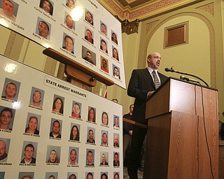 William d Lewis the vindicator  FBI agent Todd Werthspeaks during a 12-10-14 news conference at City Hall about large heroin bust. Mug shots are of those indicted