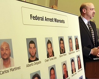 William d Lewis the vindicator  FBI agent Todd Werth speaks during a 12-10-14 news conference at City Hall about large heroin bust. Mug shots are of those indicted. Mug of  Jean Carlos Martinez is at far left. He is kingpin in the bust.