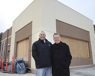Katie Rickman | The Vindicator .Marc Jakubovic 42, and his father James Jakubovic 83 pose for a photo outside of the location where their Handel's ice cream shop will be in Hermitage, PA on Thursday, Dec. 11, 2014.