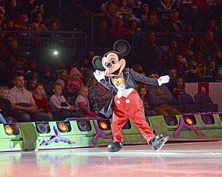 Katie Rickman | The Vindicator.Mickey Mouse skates on the ice at the Covelli Centre past a group of children and adults on Thursday, Dec. 11, 2014.