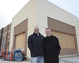 Katie Rickman | The Vindicator .Marc Jakubovic 42, and his father James Jakubovic 83 pose for a photo outside of the location where their Handel's ice cream shop will be in Hermitage, PA on Thursday, Dec. 11, 2014.