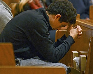 Katie Rickman | The Vindicator.Mark Fusillo 16 of Youngstown prays during a vigil for 16-year-old Lauren Petro who is in Akron Children's Hospital after collapsing earlier this week at a basketball game.