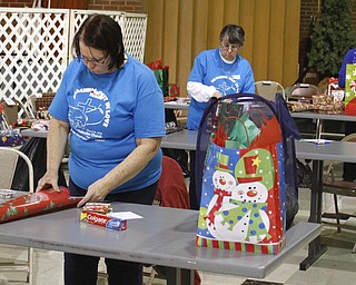        ROBERT K. YOSAY  | THE VINDICATOR..Churchill Methodist Church in Liberty - organizes, and wraps gifts for students at EJ Blott in Liberty . ..Assembly line as Sara Bowser (front) Dorothy Schultz and  Marquitta Misciskia  ( back)