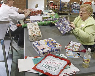        ROBERT K. YOSAY  | THE VINDICATOR..Two former teachers at EJ Blott  Marie etzler and Judy Metzler  (rt) sisters..  both help wrap gifts. Allmost a thousand gifts were wrapped....Churchill Methodist Church in Liberty - organizes, and wraps gifts for students at EJ Blott in Liberty . t