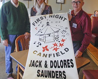        ROBERT K. YOSAY  | THE VINDICATOR..Banner Year as organizers for FIRST NIGHT CANFIELD display the banners they are trying to put in place to promote the event Dick Bowden Sarah Drokin-Director-  and Jack Saunders.. of First Night Canfield. Saunders has pushed for banners to be hung in the Village Green to raise awareness for the event. .