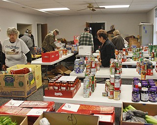        ROBERT K. YOSAY  | THE VINDICATOR.. .Canned goods, condiments, bread and boxed dinners line 12 tables inside Lake Milton Presbyterian Church..ItÕs enough to provide 20 families in the Jackson-Milton community with groceries for the holidays. .For nearly 30 years, Murle and Kaye McLaughlin have been organizing the effort to help those in need.