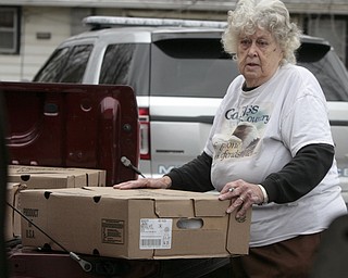        ROBERT K. YOSAY  | THE VINDICATOR..Kaye McLaughlin readies a box of frozen turkeys to be distributed .Canned goods, condiments, bread and boxed dinners line 12 tables inside Lake Milton Presbyterian Church..ItÕs enough to provide 20 families in the Jackson-Milton community with groceries for the holidays. .For nearly 30 years, Murle and Kaye McLaughlin have been organizing the effort to help those in need.