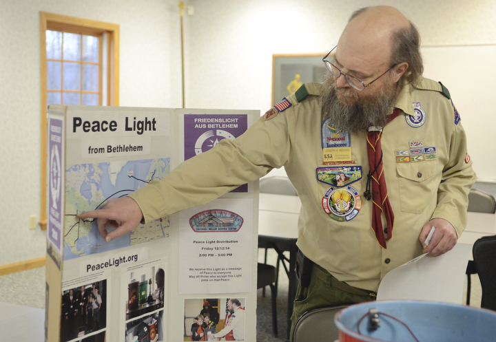 Katie Rickman | The Vindicator.Joe Reding of Bayport, Minnesota is the National Coordinator for the Peace Light points to a map showing the journey of the Peace Light on Friday, December 12, 2014 at the Greater Wester Reserve Council of Boy Scouts in Warren.