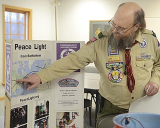 Katie Rickman | The Vindicator.Joe Reding of Bayport, Minnesota is the National Coordinator for the Peace Light points to a map showing the journey of the Peace Light on Friday, December 12, 2014 at the Greater Wester Reserve Council of Boy Scouts in Warren.
