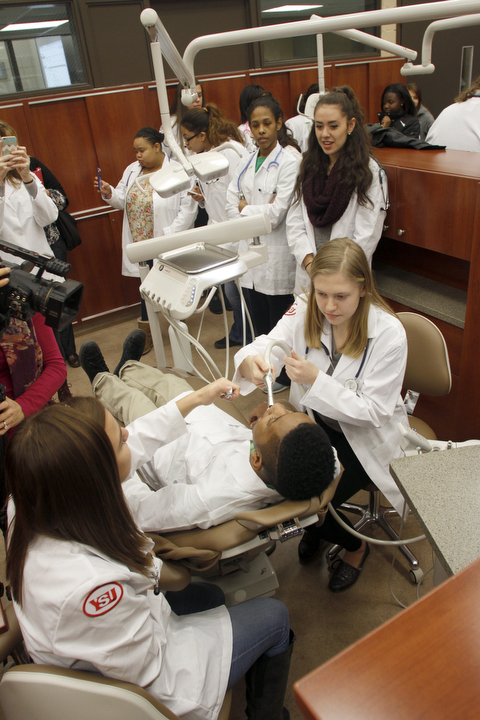        ROBERT K. YOSAY  | THE VINDICATOR..Kristin Sampson Harding 11 th  to right of chair  Valdeoso Patterson 11 Harding (chair) and  Isabella Orr  10th grade  bottom left -   watching is Alassia Dykes 10th grade and Kristen Dauber 11th grade ..YSUÕs Health Professions Affinity Community is an initiative to increase the diversity of the primary healthcare and dental workforce in the Mahoning Valley by encouraging high school students to prepare for careers in health professions.