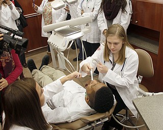        ROBERT K. YOSAY  | THE VINDICATOR..Kristin Sampson Harding 11 th  to right of chair  Valdeoso Patterson 11 Harding (chair) and  Isabella Orr  10th grade  bottom left -   watching is Alassia Dykes 10th grade and Kristen Dauber 11th grade ..YSUÕs Health Professions Affinity Community is an initiative to increase the diversity of the primary healthcare and dental workforce in the Mahoning Valley by encouraging high school students to prepare for careers in health professions.