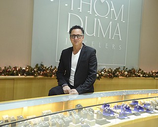 Katie Rickman | The Vindicator.Tom Duma stands in front a jewelry case at his jewelry store in Warren on Friday, Dec. 12, 2014.