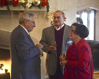 Katie Rickman | The Vindicator.L-R.Ron Rhinehart of Canfield Phil Astorino and his wife Linda of Boardman speak to one another during the cocktail hour  at the Annual Youngstown Sheet and Tube Luncheon at the Tippecanoe Country Club in Canfield on Friday, Dec. 12, 2014.