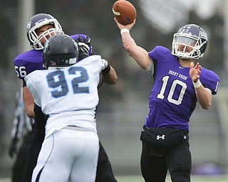 ALLIANCE, OHIO - DECEMBER 13, 2014: Kevin Burke #10 of Mount Union throws a pass from the pocket picking up a block from Brooks Jenkins #56 on Terence Gavin #92 of Wesley during the 1st half of Saturday afternoons game at Mount Union Stadium. Mount Union won 70-21. (photo by David Dermer/Youngstown Vindicator)