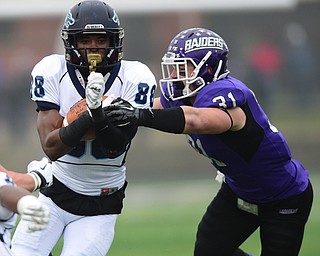 ALLIANCE, OHIO - DECEMBER 13, 2014: Steve Koudossou #88 of Weasley runs the football being being tackled by Alex Kocheff #31 of Mount Union during the 1st half of Saturday afternoons game at Mount Union Stadium. Mount Union won 70-21. (photo by David Dermer/Youngstown Vindicator)