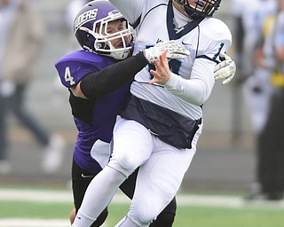 ALLIANCE, OHIO - DECEMBER 13, 2014:Joe Callahan #14 of Wesley is sacked by Hank Spencer #4 of Mount Union during the 1st half of Saturday afternoons game at Mount Union Stadium. Mount Union won 70-21. (photo by David Dermer/Youngstown Vindicator)