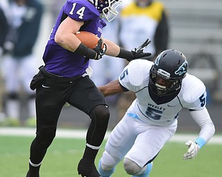 ALLIANCE, OHIO - DECEMBER 13, 2014:Tim Kennedy #14 of Mount Union stiff arms a diving Derrick Bender #5 of Wesley on his way into the end zone to score a touchdown during the 1st half of Saturday afternoons game at Mount Union Stadium. Mount Union won 70-21. (photo by David Dermer/Youngstown Vindicator)