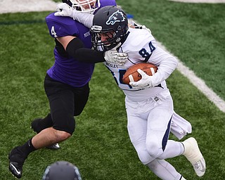 ALLIANCE, OHIO - DECEMBER 13, 2014: Andrew Monaghan #84 of Wesley is tackled near the sideline by Hank Spencer #4 of Mount Union during the 1st half of Saturday afternoons game at Mount Union Stadium. Mount Union won 70-21. (photo by David Dermer/Youngstown Vindicator)