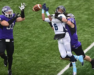 ALLIANCE, OHIO - DECEMBER 13, 2014: Nick Rodriguez #26 and Alex Kocheff #31 of Mount Union break up a pass intended for Robert Wiggs #6 of Wesley during the 1st half of Saturday afternoons game at Mount Union Stadium. Mount Union won 70-21. (photo by David Dermer/Youngstown Vindicator)